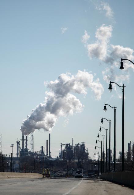 Smoke emanates from smokestacks at the Phillips 66 Bayway Refinery in Linden, New Jersey, on March 18, 2026. Oil prices surged Wednesday following a strike on a major Iranian gas facility as the Federal Reserve raised its inflation forecast while holding interest rates steady. (Photo by kena betancur / AFP)