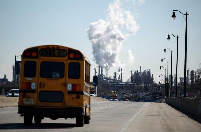 Smoke emanates from smokestacks at the Phillips 66 Bayway Refinery in Linden, New Jersey, on March 18, 2026. Oil prices surged Wednesday following a strike on a major Iranian gas facility as the Federal Reserve raised its inflation forecast while holding interest rates steady. (Photo by kena betancur / AFP)