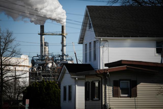 Smoke emanates from smokestacks at the Phillips 66 Bayway Refinery in Linden, New Jersey, on March 18, 2026. Oil prices surged Wednesday following a strike on a major Iranian gas facility as the Federal Reserve raised its inflation forecast while holding interest rates steady. (Photo by kena betancur / AFP)