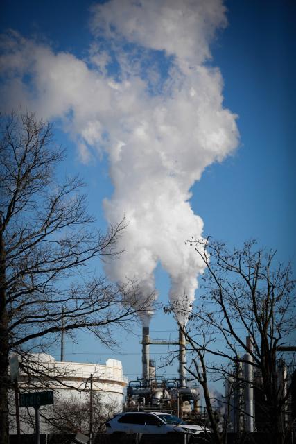 Smoke emanates from smokestacks from an oil refinery in Linden, New Jersey, on March 18, 2026. Oil prices surged Wednesday following a strike on a major Iranian gas facility as the Federal Reserve raised its inflation forecast while holding interest rates steady. (Photo by kena betancur / AFP)
