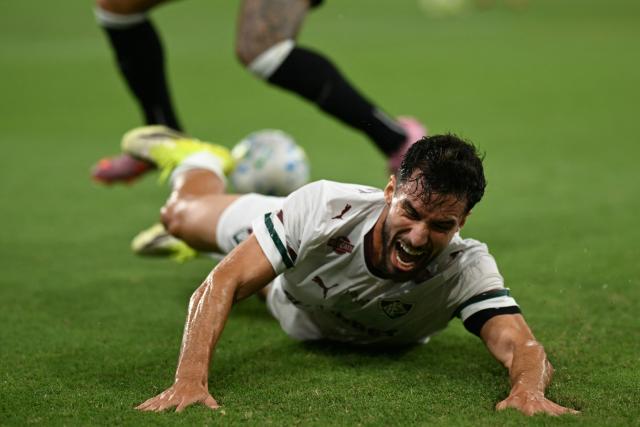 Fluminense's midfielder #08 Martinelli falls to the ground during the Brasileirao Serie A football match between Vasco da Gama and Fluminense at the Maracana Stadium in Rio de Janeiro, Brazil, on March 18, 2026. (Photo by Mauro PIMENTEL / AFP)