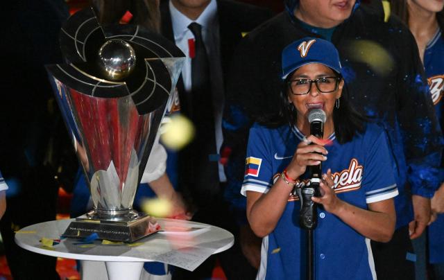 Venezuela's interim President Delcy Rodriguez speaks during an event to honor the national baseball team after its victory in the World Baseball Classic at the Miraflores Palace in Caracas on March 18, 2026. Venezuelan flags hang from windows, hundreds wear the national team's jersey, and a holiday has been declared: the country woke up celebrating on March 18 after its first World Baseball Classic title, a celebration that some even link to the fall of Nicolas Maduro. (Photo by Juan BARRETO / AFP)