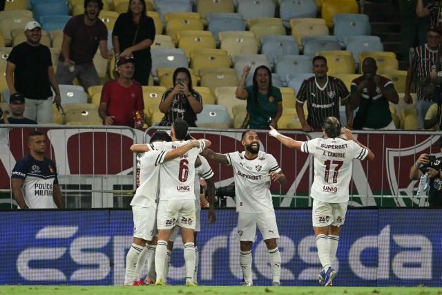 Fluminense's midfielder #35 Hercules (unseen) celebrates with teammates after scoring his team's second goal during the Brasileirao Serie A football match between Vasco da Gama and Fluminense at the Maracana Stadium in Rio de Janeiro, Brazil, on March 18, 2026. (Photo by MAURO PIMENTEL / AFP)