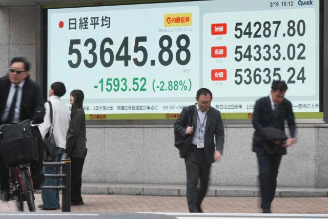 An electronic quotation board displays the Nikkei Stock Average on the Tokyo Stock Exchange along a street in Tokyo on March 19, 2026. (Photo by Kazuhiro NOGI / AFP)