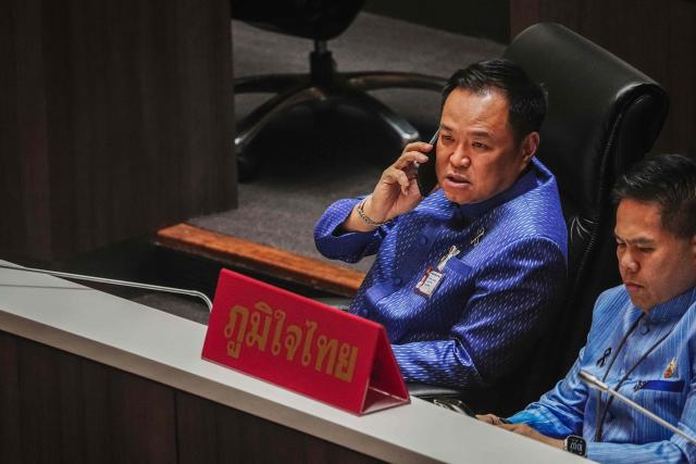Bhumjaithai Party leader Anutin Charnvirakul speaks on a phone in Parliament in Bangkok on March 19, 2026. Thailand's new parliament is set to elect Anutin as prime minister on March 19, keeping the conservative in the top office after his party routed its election rivals with a nationalist campaign. (Photo by chanakarn LAOSARAKHAM / AFP)