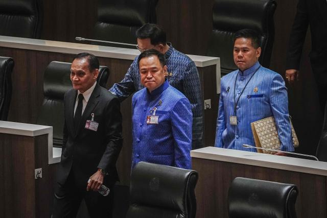 Bhumjaithai Party leader Anutin Charnvirakul (C) arrives at Parliament in Bangkok on March 19, 2026. Thailand's new parliament is set to elect Anutin as prime minister on March 19, keeping the conservative in the top office after his party routed its election rivals with a nationalist campaign. (Photo by chanakarn LAOSARAKHAM / AFP)