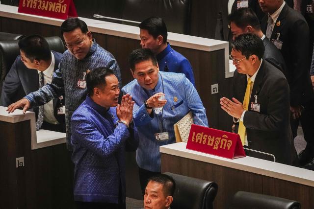 Bhumjaithai Party leader Anutin Charnvirakul gestures as he arrives with members in Parliament in Bangkok on March 19, 2026. Thailand's new parliament is set to elect Anutin as prime minister on March 19, keeping the conservative in the top office after his party routed its election rivals with a nationalist campaign. (Photo by chanakarn LAOSARAKHAM / AFP)