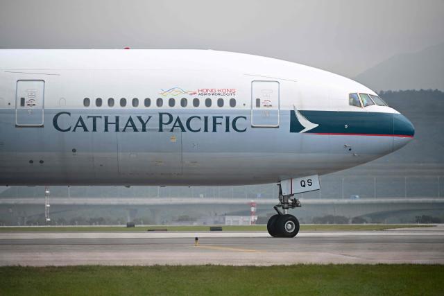 (FILES) A Cathay Pacific passenger plane prepares to take off from Hong Kong's international airport on March 13, 2019. Hong Kong aviation giant Cathay Pacific has suspended flights to and from Dubai until the end of April over the war in the Middle East, the company said in a statement on march 19, 2026. (Photo by Anthony WALLACE / AFP)
