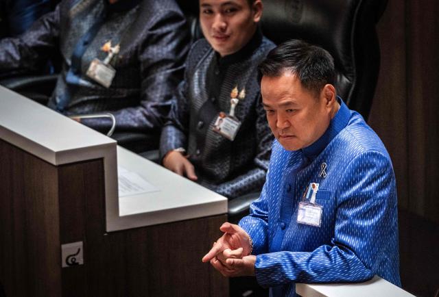 Thailand's caretaker Prime Minister and Bhumjaithai Party leader Anutin Charnvirakul (R) looks on during a vote at Parliament in Bangkok on March 19, 2026. Thailand's new parliament elected Anutin Charnvirakul as prime minister, according to an AFP tally of the vote, keeping the conservative in the top office after his party routed its election rivals. (Photo by Chanakarn LAOSARAKHAM / AFP)