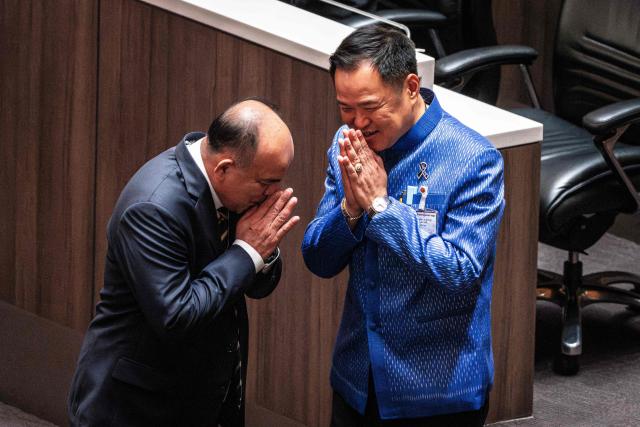 Thailand's caretaker Prime Minister and Bhumjaithai Party leader Anutin Charnvirakul (R) gestures at Parliament in Bangkok on March 19, 2026. Thailand's new parliament elected Anutin Charnvirakul as prime minister, according to an AFP tally of the vote, keeping the conservative in the top office after his party routed its election rivals. (Photo by chanakarn LAOSARAKHAM / AFP)