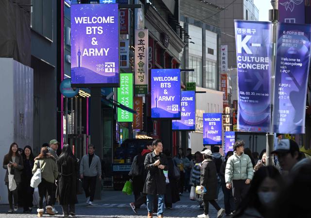 Messages welcoming BTS fans are displayed on electronic billboards at Myeongdong shopping district in Seoul on March 19, 2026, ahead of the comeback concert of K-pop boy group BTS. BTS, the world's biggest boy band, reunites on stage on March 21, in a K-pop extravaganza watched by hundreds of thousands of fans in downtown Seoul and by millions around the planet online. (Photo by Jung Yeon-je / AFP)