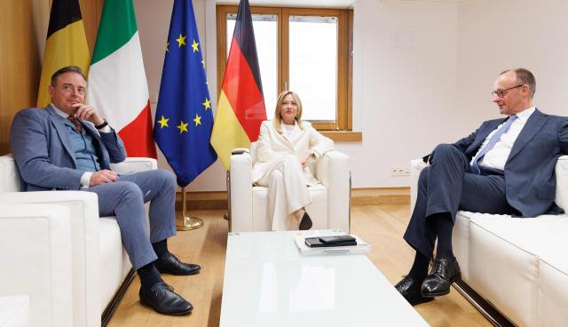 (From L) Belgian Prime Minister Bart De Wever, Italian Prime Minister Giorgia Meloni and German Chancellor Frierdrich Merz meet on the sidelines of a EU Summit at the EU headquarters in Brussels, on March 19, 2026. European Union leaders meet in the context of the US-Israeli war against Iran that is consuming the Middle East, and its consequences on energy prices and security. (Photo by BENOIT DOPPAGNE / Belga / AFP) / Belgium OUT