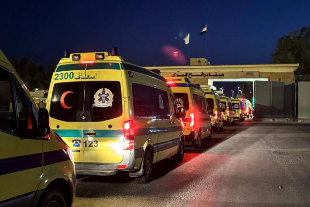 Ambulances wait on the Egyptian side of the Rafah border crossing with the Gaza Strip early on March 19, 2026. Gaza's border crossing with Egypt reopened on March 19 for a limited number of people, Palestinian and Egyptian officials told AFP, for the first time since Israel and the United States launched strikes on Iran. (Photo by Amr ADEL / AFP)