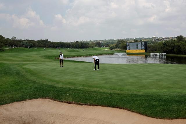 Wild Card Canadian player Richard T. Lee (C) putts on the 12th green on the first day of the LIV Golf South Africa tournament at The Club in Steyn City on March 19, 2026. (Photo by PHILL MAGAKOE / AFP)