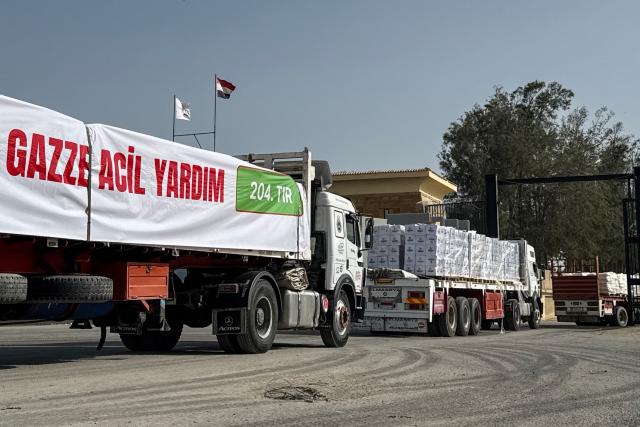 Trucks transporting humanitarian aid enter through the Egyptian side of the Rafah border crossing with the Gaza Strip on March 19, 2026. Gaza's border crossing with Egypt reopened on March 19 for a limited number of people, Palestinian and Egyptian officials told AFP, for the first time since Israel and the United States launched strikes on Iran. (Photo by Amr ADEL / AFP)