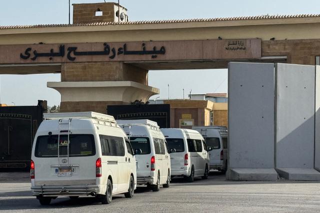 Minibuses carrying Palestinians wishing to return to the Gaza Strip line up on the Egyptian side of the Rafah border crossing on March 19, 2026. Gaza's border crossing with Egypt reopened on March 19 for a limited number of people, Palestinian and Egyptian officials told AFP, for the first time since Israel and the United States launched strikes on Iran. (Photo by Amr ADEL / AFP)
