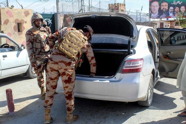 Pakistani soldiers inspect a vehicle at the Pakistan-Afghanistan border in Chaman, Balochistan province on March 19, 2026. Pakistan and Afghanistan on March 18 announced a halt in fighting during celebrations for the end of Ramadan, after the deadliest strike in their escalating conflict killed hundreds in Kabul earlier this week. (Photo by Abdul BASIT / AFP)