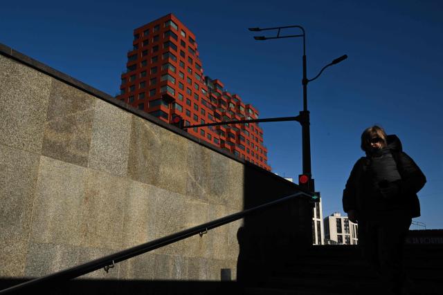 A woman enters an underground crossroad in central Moscow on March 19, 2026. (Photo by Igor IVANKO / AFP)