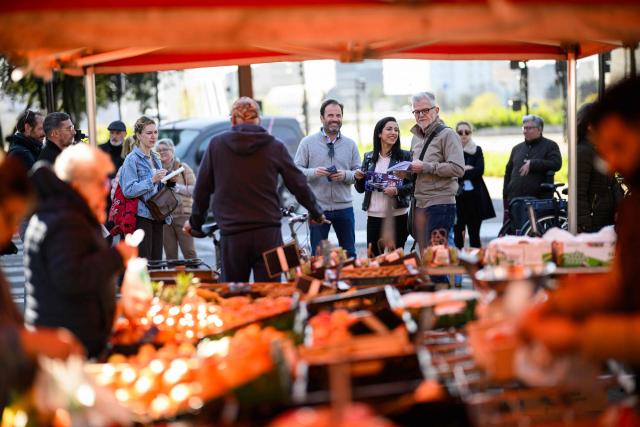 Foulques Chombart de Lauwe (centre L), candidate for mayor of Nantes for the right-wing party Les Rйpublicains (LR), distributes electoral flyers alongside France’s High Commissioner for Children, Sarah El Haпry (centre R), at a market in Nantes, western France, on March 19, 2026, ahead of the second round of the 2026 municipal elections. (Photo by Loic VENANCE / AFP)