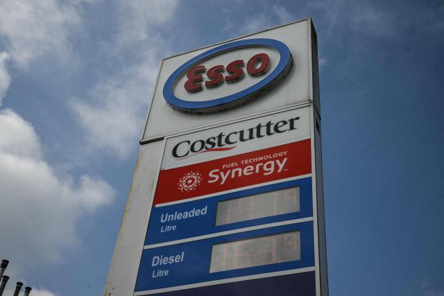 A sign showing prices at an Esso petrol service station is pictured in Huddersfield, northern England on March 19, 2026. Britain's energy minister warned petrol retailers on March 13 that the government would not tolerate "unfair practices" amid a row over rising fuel prices sparked by the Middle East war. European gas prices soared as much as 35 percent on March 19 as fresh strikes hit energy infrastructure in the Middle East, including Qatar's main gas facility. (Photo by Oli SCARFF / AFP)