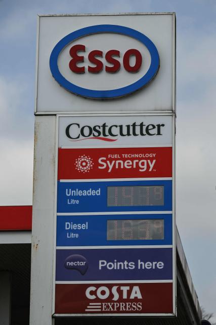 A sign showing prices at an Esso petrol service station is pictured in Huddersfield, northern England on March 19, 2026. Britain's energy minister warned petrol retailers on March 13 that the government would not tolerate "unfair practices" amid a row over rising fuel prices sparked by the Middle East war. European gas prices soared as much as 35 percent on March 19 as fresh strikes hit energy infrastructure in the Middle East, including Qatar's main gas facility. (Photo by Oli SCARFF / AFP)