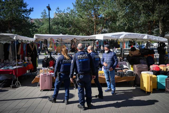 Municipal police officers patrol in a market in Nantes, western France, on March 19, 2026. (Photo by Loic VENANCE / AFP)