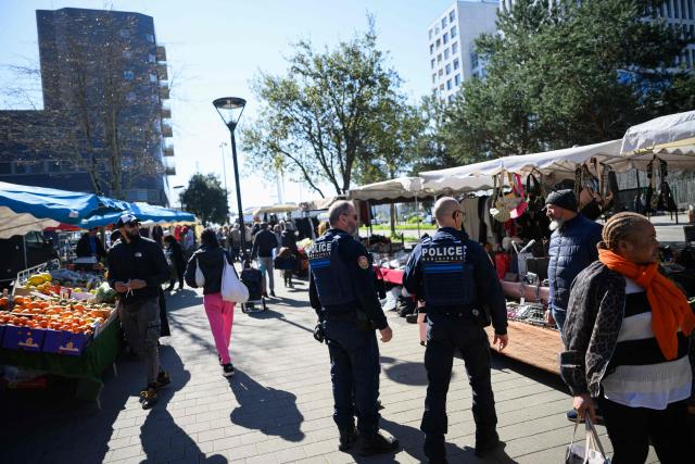 Municipal police officers patrol in a market in Nantes, western France, on March 19, 2026. (Photo by Loic VENANCE / AFP)