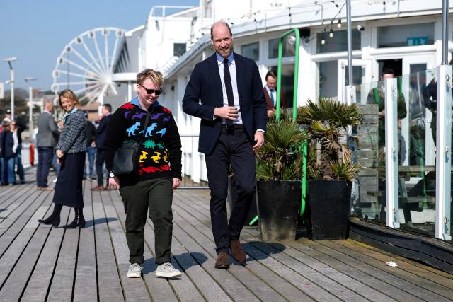 Britain's William, Prince of Wales meets Theo from the Prince's homelessness programme Homewards National Co-Production Group, during a visit to Bournemouth pier, in Bournemouth, southern England on March 19, 2026. (Photo by Isabel Infantes / POOL / AFP)
