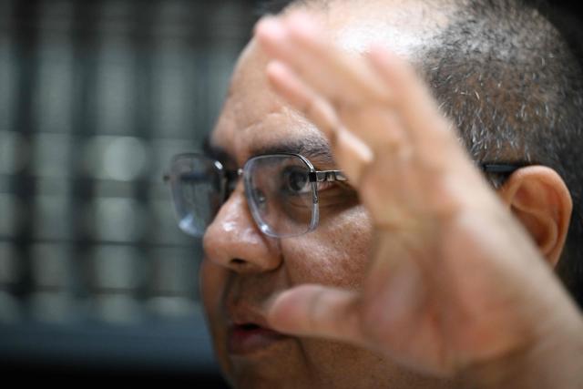 Attorney Louis Benavides, husband of human rights lawyer and head of the anti-corruption department of the NGO Cristosal, Ruth Lopez, gestures during an AFP interview in San Salvador on March 16, 2026. In an interview with AFP on March 16, 2026, Louis Benavides, the husband of the renowned human rights activist, stated that Salvadoran lawyer Ruth Lуpez embodies “decency” and a “fearless” voice that Nayib Bukele’s government managed to silence solely through imprisonment. (Photo by AFP)
