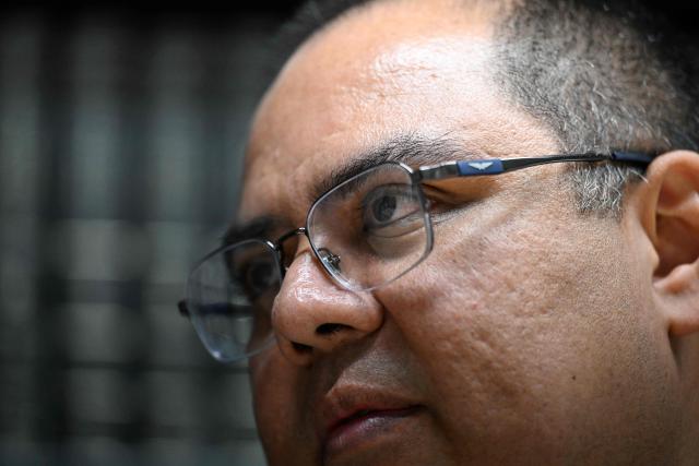 Attorney Louis Benavides, husband of human rights lawyer and head of the anti-corruption department of the NGO Cristosal, Ruth Lopez, gestures during an AFP interview in San Salvador on March 16, 2026. In an interview with AFP on March 16, 2026, Louis Benavides, the husband of the renowned human rights activist, stated that Salvadoran lawyer Ruth Lуpez embodies “decency” and a “fearless” voice that Nayib Bukele’s government managed to silence solely through imprisonment. (Photo by AFP)