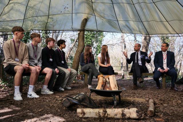 Britain's Prince William (2nd R), Prince of Wales meets with principal Mark Avoth (R) and students during a visit to the Bourne Academy, a co-educational state-funded secondary school and sixth form in Bournemouth, southern England on March 19, 2026, to hear about pioneering youth schemes, supported by the Homewards programme, which work to stop homelessness. (Photo by Adrian DENNIS / POOL / AFP)