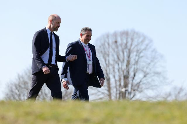 Britain's Prince William, Prince of Wales chats with principal Mark Avoth (R) during a visit to the Bourne Academy, a co-educational state-funded secondary school and sixth form in Bournemouth, southern England on March 19, 2026, to hear about pioneering youth schemes, supported by the Homewards programme, which work to stop homelessness. (Photo by Adrian Dennis / POOL / AFP)