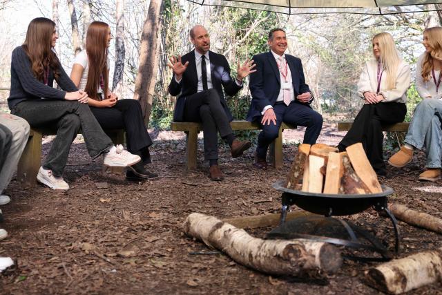 Britain's Prince William (C), Prince of Wales meets with principal Mark Avoth (3rd R) and students during a visit to the Bourne Academy, a co-educational state-funded secondary school and sixth form in Bournemouth, southern England on March 19, 2026, to hear about pioneering youth schemes, supported by the Homewards programme, which work to stop homelessness. (Photo by Adrian DENNIS / POOL / AFP)