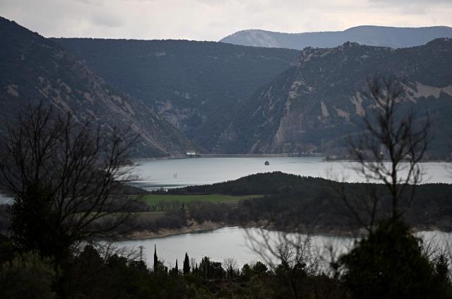 This photograph taken on March 19, 2026 shows a view of the Mediano reservoir amid high water level, in Mediano, Huesca province. This long-term project shows an inventory of several sites in Spain which are suffering from drought. Photos of the same places are taken every month over a very long period. (Photo by ANDER GILLENEA / AFP)
