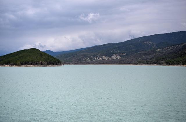 This photograph taken on March 19, 2026 shows a view of the Mediano reservoir amid high water level, in Mediano, Huesca province. This long-term project shows an inventory of several sites in Spain which are suffering from drought. Photos of the same places are taken every month over a very long period. (Photo by ANDER GILLENEA / AFP)