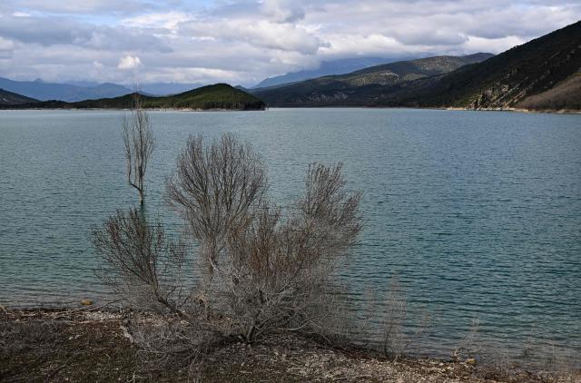 This photograph taken on March 19, 2026 shows a view of the Mediano reservoir amid high water level, in Mediano, Huesca province. This long-term project shows an inventory of several sites in Spain which are suffering from drought. Photos of the same places are taken every month over a very long period. (Photo by ANDER GILLENEA / AFP)