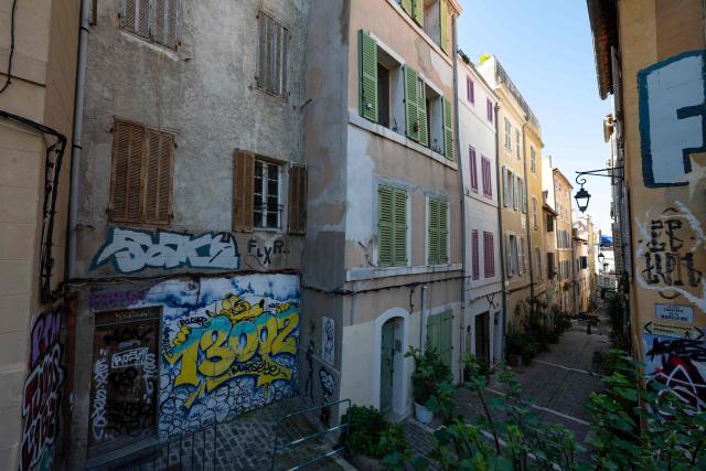 This photograph shows graffiti and facades in the Panier district in Marseille, southern France, on March 19, 2026. (Photo by Elodie CLEMENT / AFP)