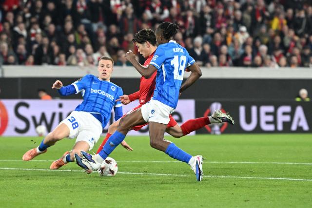 Freiburg's Japanese midfielder #14 Yuito Suzuki ((C) kicks the ball to score the 4-1 goal during the UEFA Europa League, last 16 second leg, football match between SC Freiburg and KRC Genk in Freiburg, southwestern Germany, on March 19, 2026.  (Photo by THOMAS KIENZLE / AFP)