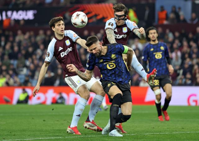 Lille's French striker #09 Olivier Giroud (C) attempts a header at goal under pressure from ing the UEFA Europa League, round of Aston Villa's Spanish defender  #16 Andres Garcia (L) and Aston Villa's Swedish defender #03 Victor Lindelof during the UEFA Europa League second-leg football match between Aston Villa and Lille LOSC at Villa Park in Birmingham, central England on March 19, 2026. (Photo by Darren Staples / AFP)