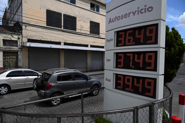 The new fuel prices are seen on a board at a gas station in Guatemala City on March 19, 2026. The prices of petroleum derivatives soared in Guatemala due to the war in the Middle East. (Photo by JOHAN ORDONEZ / AFP)