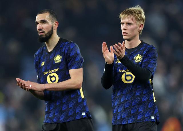 Lille's Algerian midfielder #06 Nabil Bentaleb (L) and Lille's Icelandic midfielder #10 Hakon Haraldsson applauds the fans following the UEFA Europa League, round of 16 second-leg football match between Aston Villa and Lille LOSC at Villa Park in Birmingham, central England on March 19, 2026. Villa won the match 2-0. (Photo by Darren Staples / AFP)