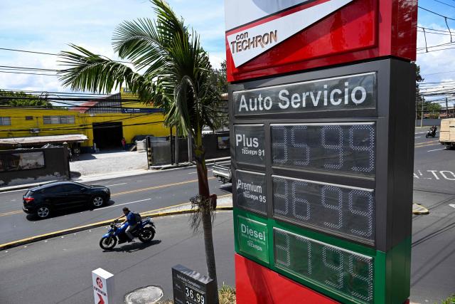 The new fuel prices are seen on a board at a gas station in Guatemala City on March 19, 2026. The prices of petroleum derivatives soared in Guatemala due to the war in the Middle East. (Photo by JOHAN ORDONEZ / AFP)