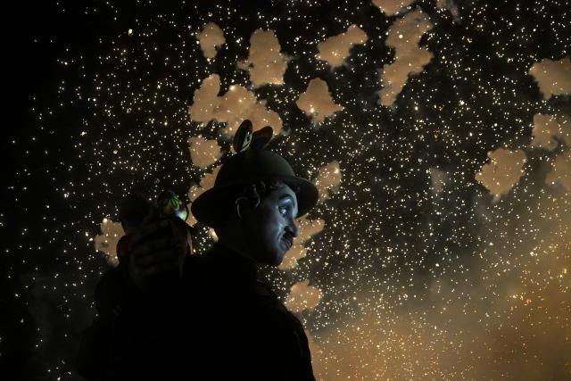 A 'ninot' (cardboard figurine whose name literally means 'doll' in Valencian language) depicting Charles Chaplin, burns during the "Nit de la Crema" (the night of the burning) on the last night of the Fallas Festival in Valencia on March 19, 2026. The 'fallas' —gigantic cardboard structures depicting current events and celebrities, with individual figures known as 'ninots'— are burned in the streets of Valencia on March 19 as a tribute to Saint Joseph, the patron saint of the carpenters' guild." (Photo by Jose JORDAN / AFP)