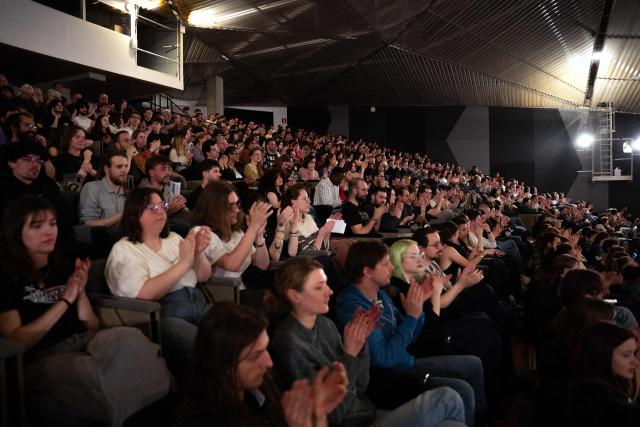 Supporters of French left-wing party La France Insoumise (LFI) applaud during a campaign meeting of Lille's mayoral candidate in Lille, northern France on March 19, 2026, ahead of the second round of France's 2026 municipal elections. French voters are scheduled to head to the polls for the second round of municipal elections on March 22, 2026. (Photo by Elise HOUBEN / AFP)