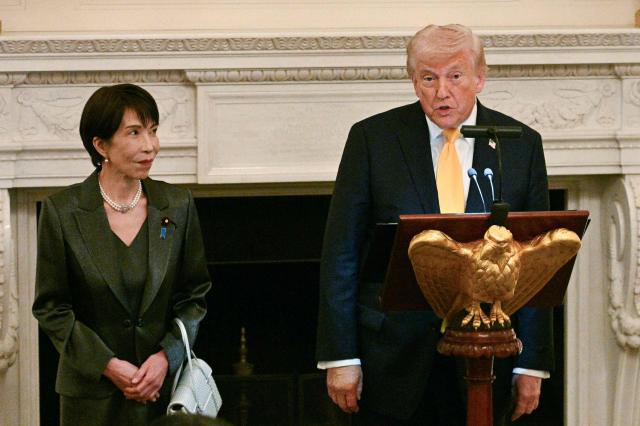 US President Donald Trump speaks with Japan's Prime Minister Sanae Takaichi standing next to him at a dinner in the State Dining Room of the White House in Washington on March 19, 2026. (Photo by Jim WATSON / AFP)