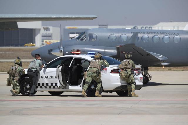 Soldiers of the Mexican Army and agents of the National Guard participate in an aircraft-hijacking drill as part of ‘Exercise Ollamani’ at the Santa Lucia Military Base in the municipality of Zumpango, State of Mexico, Mexico, on March 19, 2026. "Exercise Ollamani" is organized by various institutions—including the Mexican Army, the National Guard, and the Attorney General's Office—and serves as an anti-terrorism drill designed to safeguard the 2026 World Cup. (Photo by Alfredo ESTRELLA / AFP)