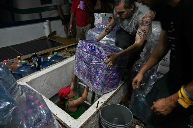 Activists organize bags of aid inside a boat, nicknamed ‘Grandma 2’, as they prepare for its departure to deliver humanitarian assistance to Cuba, as part of the Convoy to Cuba organized by left?wing activists from various countries in the Americas and Europe, in Puerto Progreso, Yucatбn state, Mexico, on March 19, 2026. The first shipment of international aid for crisis-hit Cuba arrived in the country from Europe on March 18, 2026 in the shape of five tons of medical supplies. (Photo by YURI CORTEZ / AFP)