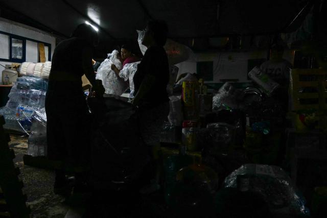 Activists organize bags of aid inside a boat, nicknamed ‘Grandma 2’, as they prepare for its departure to deliver humanitarian assistance to Cuba, as part of the Convoy to Cuba organized by left?wing activists from various countries in the Americas and Europe, in Puerto Progreso, Yucatбn state, Mexico, on March 19, 2026. The first shipment of international aid for crisis-hit Cuba arrived in the country from Europe on March 18, 2026 in the shape of five tons of medical supplies. (Photo by YURI CORTEZ / AFP)