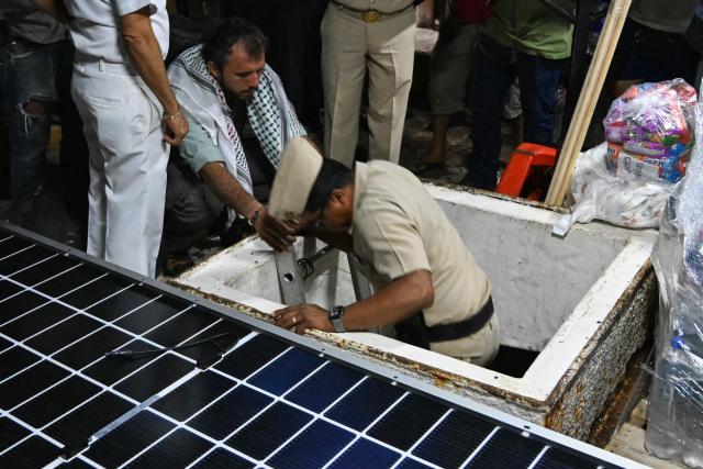 Officials from the Puerto Progreso Port Captaincy inspect the inside of a boat, nicknamed ‘Grandma 2’, as they prepare for its departure to deliver humanitarian assistance to Cuba, as part of the Convoy to Cuba organized by left-wing activists from various countries in the Americas and Europe, in Puerto Progreso, Yucatan state, Mexico, on March 19, 2026. The first shipment of international aid for crisis-hit Cuba arrived in the country from Europe on March 18, 2026 in the shape of five tons of medical supplies. (Photo by YURI CORTEZ / AFP)