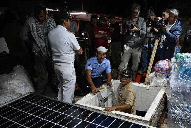Officials from the Puerto Progreso Port Captaincy inspect the inside of a boat, nicknamed ‘Grandma 2’, as they prepare for its departure to deliver humanitarian assistance to Cuba, as part of the Convoy to Cuba organized by left-wing activists from various countries in the Americas and Europe, in Puerto Progreso, Yucatan state, Mexico, on March 19, 2026. The first shipment of international aid for crisis-hit Cuba arrived in the country from Europe on March 18, 2026 in the shape of five tons of medical supplies. (Photo by YURI CORTEZ / AFP)